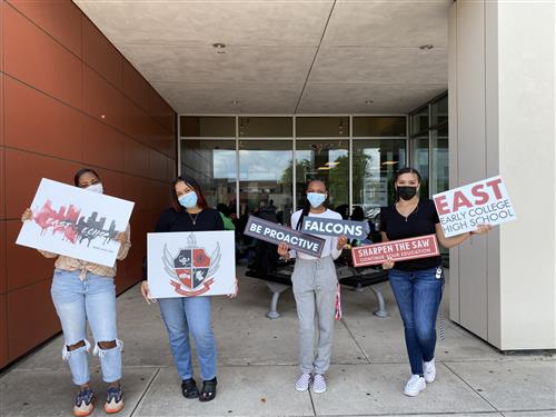 Students with school signs