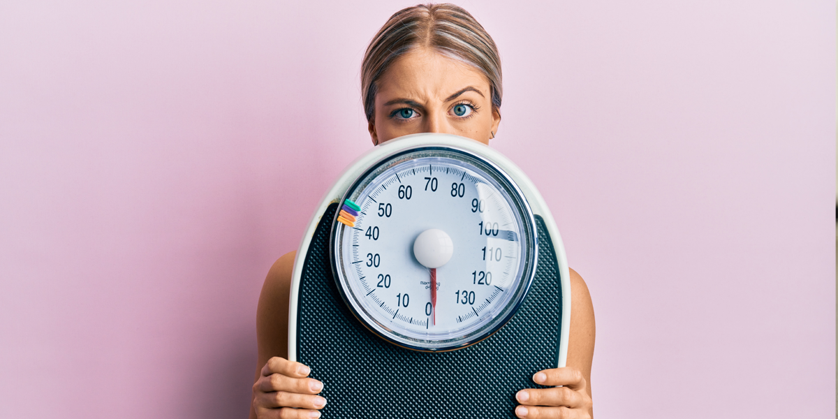 woman with weight scale