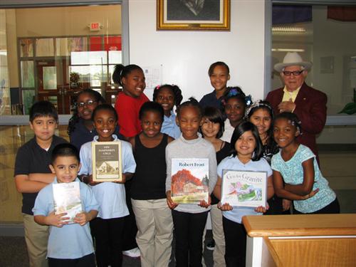Frost students accepting books from the Frost Trust 