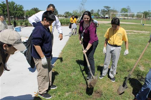 Mrs. Parra planting a tree.